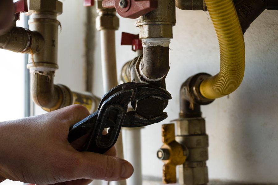 How Do You Maintain Your Commercial Boiler? Image of boiler pipes being serviced.