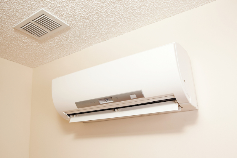 How a Ductless Mini Split Can Benefit Your Facility. A wall-mount mini-split heating and air conditioning unit installed in a new house. A modern heat pump, this unit heats a house in winter and cools in the summer. This type of system eliminates ductwork which is a primary source of inefficiency in a conventional system making this about 30% more efficient. This particular unit has an eye sensor which pans the room looking for hot or cold spots and directs the airflow accordingly.