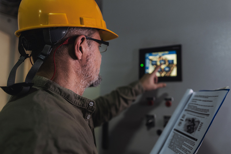 Technician performing maintenance on electrical system.