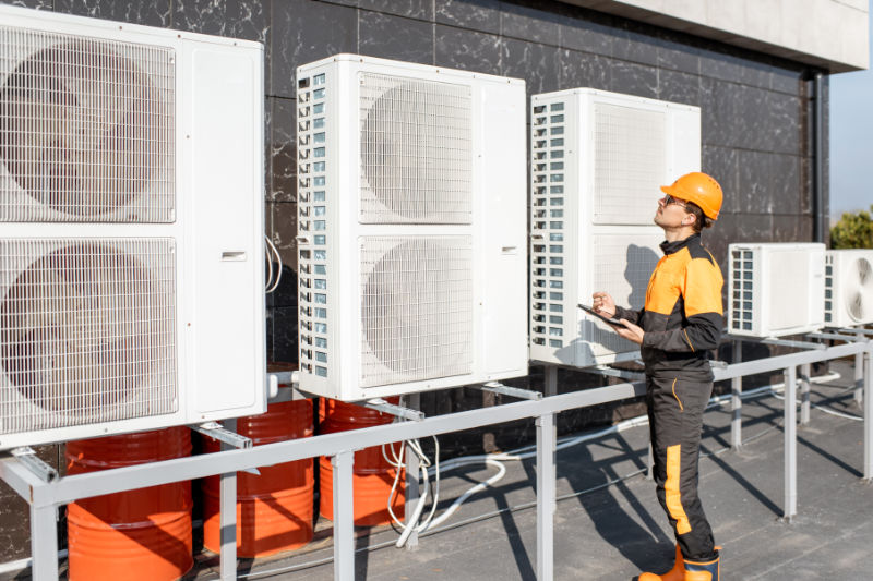 man checking the hvac system outdoors