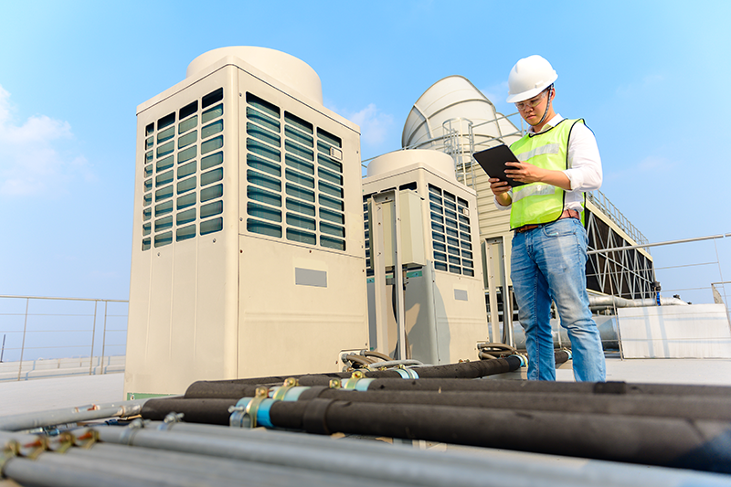 Man checking a commercial hvac unit