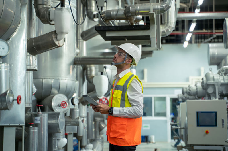 HVAC technician looking at a commercial boiler.