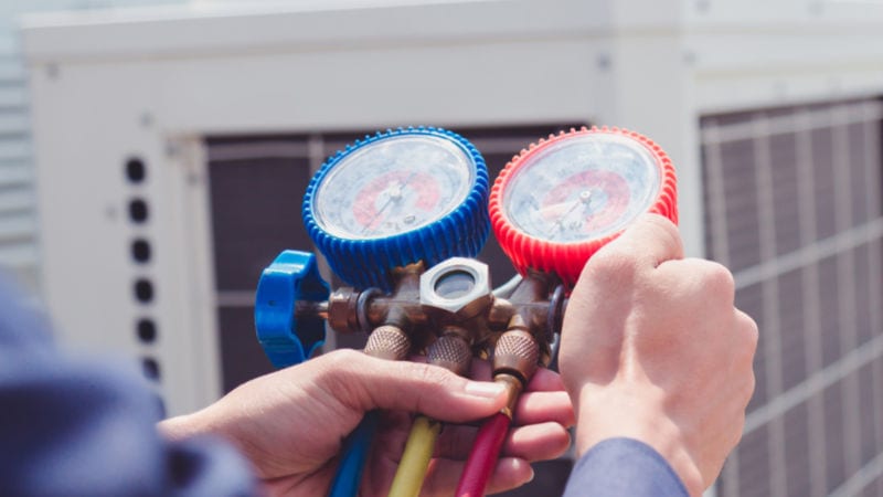 Technician is checking air conditioner ,measuring equipment for filling air conditioners. Technician is checking air conditioner ,measuring equipment for filling air conditioners.