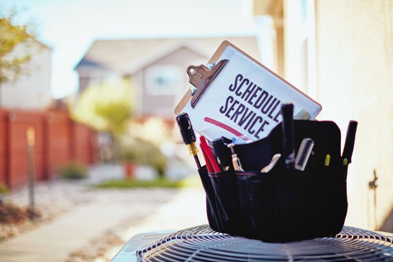 Image of HVAC unit with a service sign on top. How to Save a Ton of Money.